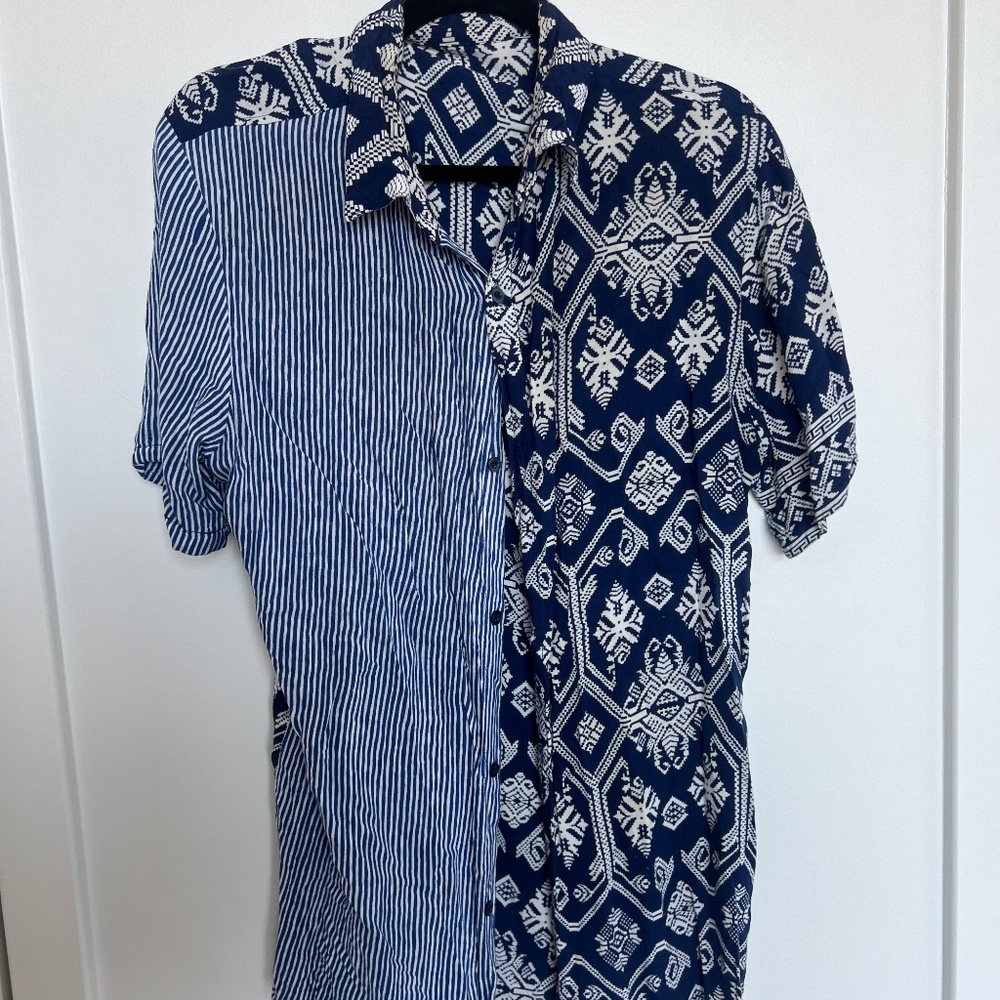 short-sleeve button-up shirt features a unique half-and-half design